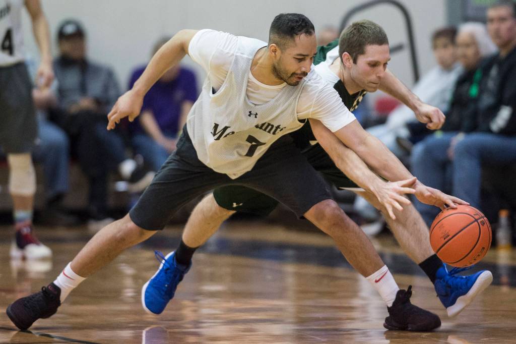 Metlakatlas Chris Bryant, left, and Haines Kyle Fossman chase a loose ball during their B bracket game at the Juneau Lions Club 73rd Annual Gold Medal Basketball Tournament at Juneau-Douglas High School on Friday, March 22, 2019. (Michael Penn | Juneau Empire)