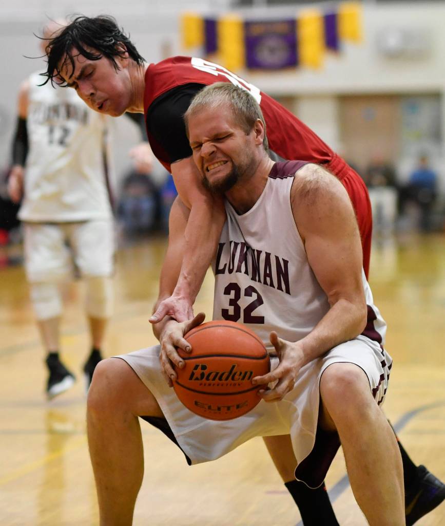 Hoonahs Donald Dybdahl, left, attempts to get the ball from Klukwans Coleman Stanford during their C bracket game at the Juneau Lions Club 73rd Annual Gold Medal Basketball Tournament at Juneau-Douglas High School on Friday, March 22, 2019. Klukwan won 88-67. (Michael Penn | Juneau Empire)