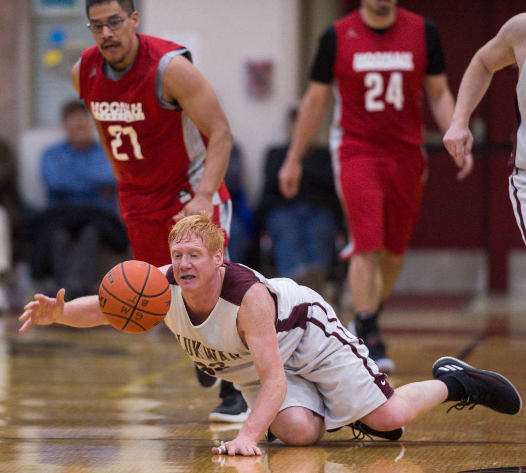 Klukwans Jesse McGraw, bottom, is fouled by Hoonahs Lucas Johnson, top left, during their C bracket game at the Juneau Lions Club 73rd Annual Gold Medal Basketball Tournament at Juneau-Douglas High School on Friday, March 22, 2019. Klukwan won 88-67. (Michael Penn | Juneau Empire)