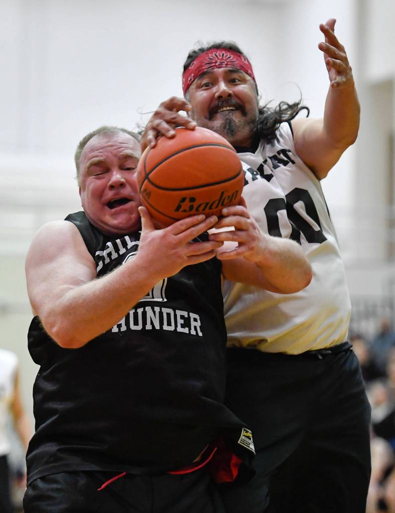 Klukwans Eric McCormick, left, and Yakutats Gary Klushkan battle for a rebound during their Masters bracket game at the Juneau Lions Club 73rd Annual Gold Medal Basketball Tournament at Juneau-Douglas High School on Friday, March 22, 2019. Klukwan won 63-58. (Michael Penn | Juneau Empire)