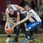 Klukwans Mike Bott, center, is pressured by Yakutats Sam Demmert, left, and Bob Lekanof during their Masters bracket game at the Juneau Lions Club 73rd Annual Gold Medal Basketball Tournament at Juneau-Douglas High School on Friday, March 22, 2019. Klukwan won 63-58. (Michael Penn | Juneau Empire)