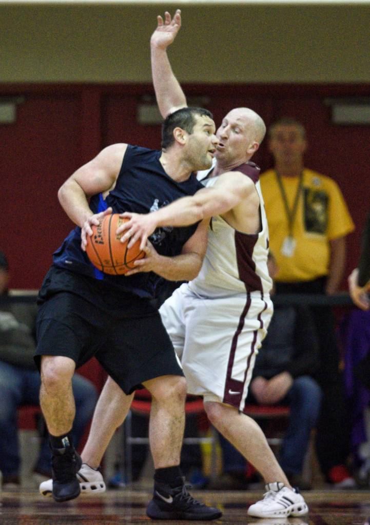 Hydaburgs Fred Hamilton, left, is guarded by Klukwans Brian Friske in the C bracket final at the Gold Medal Basketball Tournament on Saturday, March 23, 2019. (Michael Penn | Juneau Empire)
