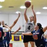 Skagways Kailyn Jerod shoots over Yakutats Cheyenne Ekis, left, Lorena Williams, center, and Nadine Fraker during the womens bracket game at the Gold Medal Basketball Tournament on Thursday, March 21, 2019. (Michael Penn | Juneau Empire)