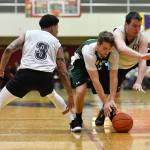 Haines Orion Falvey, center, is pressured by Angoons Dominique Brinson, left, and John Croasmun Jr. in the B final at the Gold Medal Basketball Tournament on Saturday, March 23, 2019. Haines won 88-80. (Michael Penn | Juneau Empire)