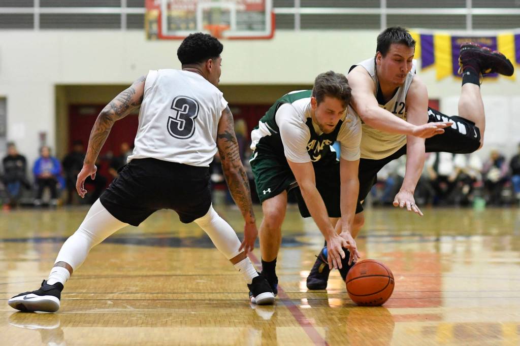 Haines Orion Falvey, center, is pressured by Angoons Dominique Brinson, left, and John Croasmun Jr. in the B final at the Gold Medal Basketball Tournament on Saturday, March 23, 2019. Haines won 88-80. (Michael Penn | Juneau Empire)