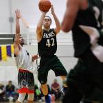 Haines Kyle Fossman shoots for three against Angoons Aquino Brinson in the B final at the Gold Medal Basketball Tournament on Saturday, March 23, 2019. Haines won 88-80. (Michael Penn | Juneau Empire)