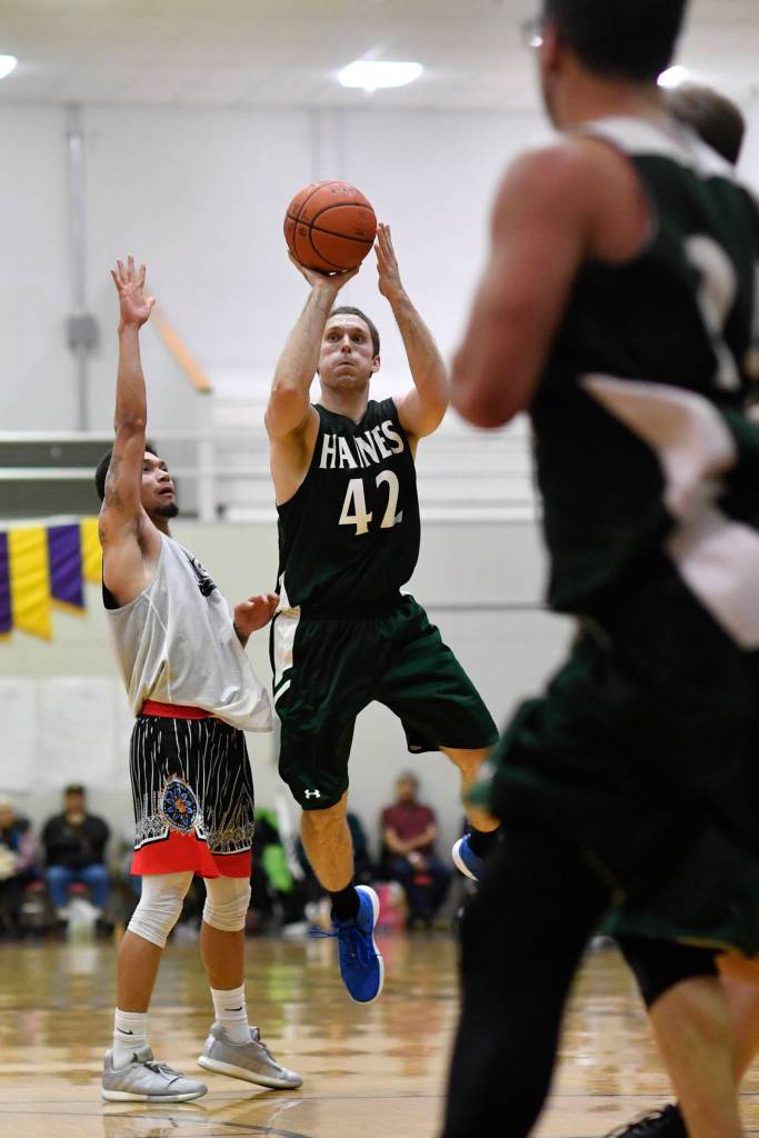 Haines Kyle Fossman shoots for three against Angoons Aquino Brinson in the B final at the Gold Medal Basketball Tournament on Saturday, March 23, 2019. Haines won 88-80. (Michael Penn | Juneau Empire)