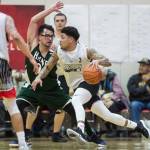 Angoons Dominique Brinson drives against Haines James Hart in the B final at the Gold Medal Basketball Tournament on Saturday, March 23, 2019. Haines won 88-80. (Michael Penn | Juneau Empire)