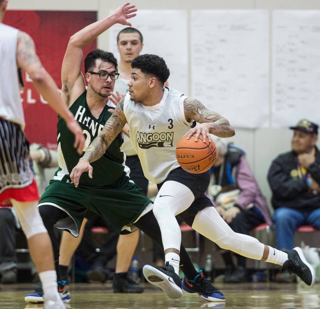 Angoons Dominique Brinson drives against Haines James Hart in the B final at the Gold Medal Basketball Tournament on Saturday, March 23, 2019. Haines won 88-80. (Michael Penn | Juneau Empire)