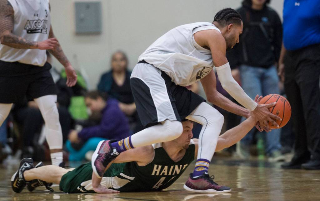 Haines Brian Combs, below, and Hydaburgs Clayton Edwin chase a loose ball the B final at the Gold Medal Basketball Tournament on Saturday, March 23, 2019. Haines won 88-80. (Michael Penn | Juneau Empire)