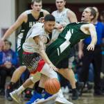 Haines Kyle Fossman draws a charging call against Angoons Aquino Brinson in the B final at the Gold Medal Basketball Tournament on Saturday, March 23, 2019. Haines won 88-80. (Michael Penn | Juneau Empire)