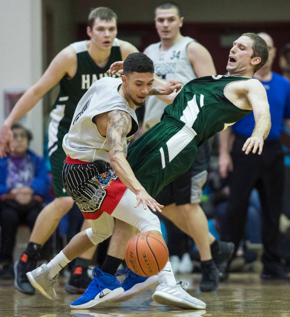 Haines Kyle Fossman draws a charging call against Angoons Aquino Brinson in the B final at the Gold Medal Basketball Tournament on Saturday, March 23, 2019. Haines won 88-80. (Michael Penn | Juneau Empire)
