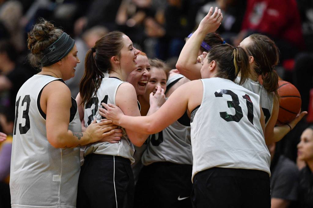Skagway gather to celebrate their win over Haines in the womens final at the Gold Medal Basketball Tournament on Saturday, March 23, 2019. Skagway won 58-49. (Michael Penn | Juneau Empire)