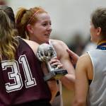 Skagway Jesse Ellis, center, receives congratulations from teammate Kaitlyn Jeron, right, and Haines Rachel Brittenham after receiving the MVP award in the womens final at the Gold Medal Basketball Tournament on Saturday, March 23, 2019. Skagway won 58-49. (Michael Penn | Juneau Empire)
