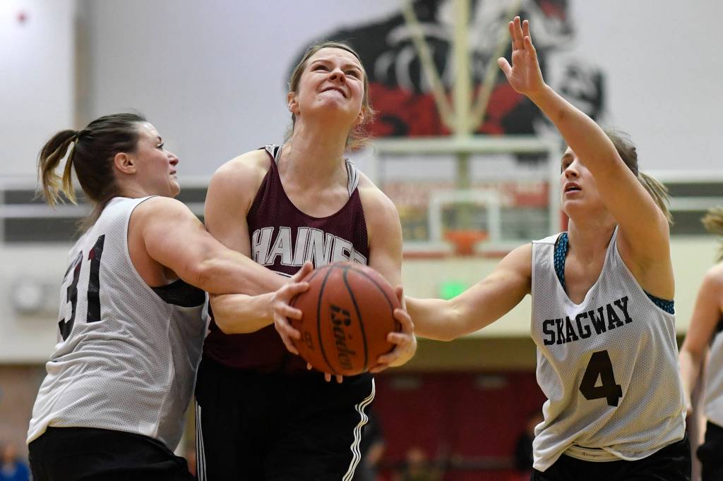 Haines Alisa Beske, center, is fouled by Skagways Tiffanie Ames, left, in the womens final at the Gold Medal Basketball Tournament on Saturday, March 23, 2019. Skagway won 58-49. (Michael Penn | Juneau Empire)