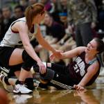 Skagways Jesse Ellis, left, helps Haines Rachel Brittenham up after they had a mid-court collision in the womens final at the Gold Medal Basketball Tournament on Saturday, March 23, 2019. Skagway won 58-49. (Michael Penn | Juneau Empire)