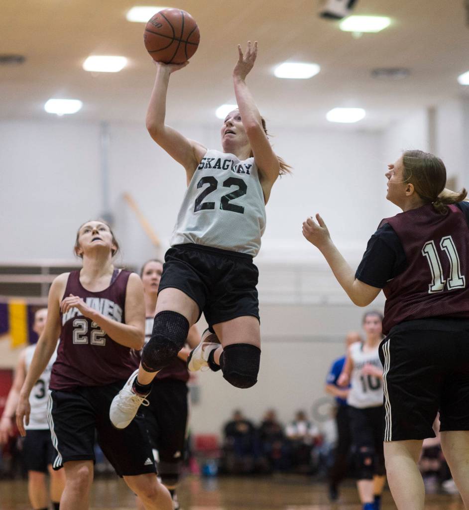 Skagway Jesse Ellis, center, shoots against Haines Fran Daly, right, in the womens final at the Gold Medal Basketball Tournament on Saturday, March 23, 2019. Skagway won 58-49. (Michael Penn | Juneau Empire)