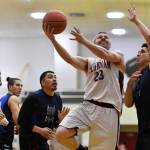 Klukwans Michael Ganey, center, shoots against Hydaburgs Ben Young in the C final at the Gold Medal Basketball Tournament on Saturday, March 23, 2019. Hydaburg won 93-81. (Michael Penn | Juneau Empire)