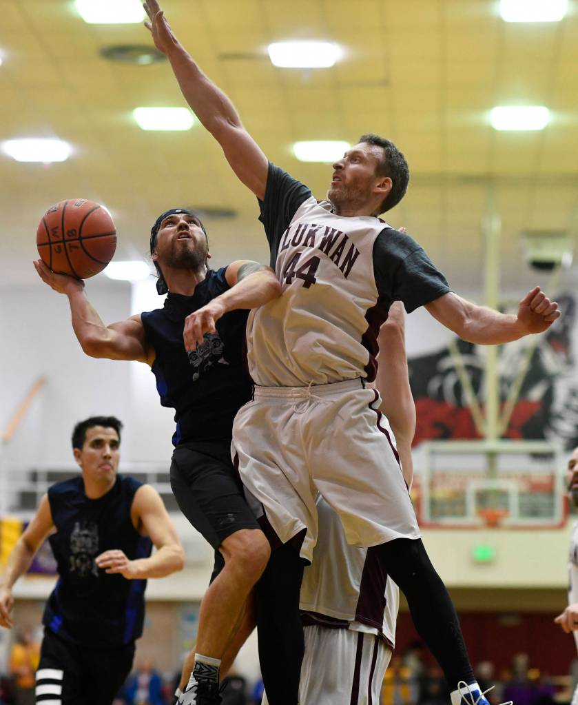Hydaburgs Joe Young, left, shoots against Klukwans Andrew Friske in the C final at the Gold Medal Basketball Tournament on Saturday, March 23, 2019. Hydaburg won 93-81. (Michael Penn | Juneau Empire)