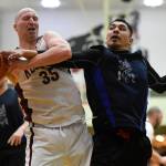 Klukwans Brian Friske, left, battles Hydaburgs Harold Dilts in the C final at the Gold Medal Basketball Tournament on Saturday, March 23, 2019. Hydaburg won 93-81. (Michael Penn | Juneau Empire)