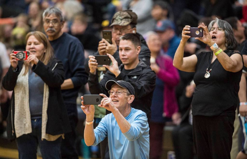 Family and friends photograph the winning Hydaburg team after they beat Klukwan in the C final at the Gold Medal Basketball Tournament on Saturday, March 23, 2019. Hydaburg won 93-81. (Michael Penn | Juneau Empire)