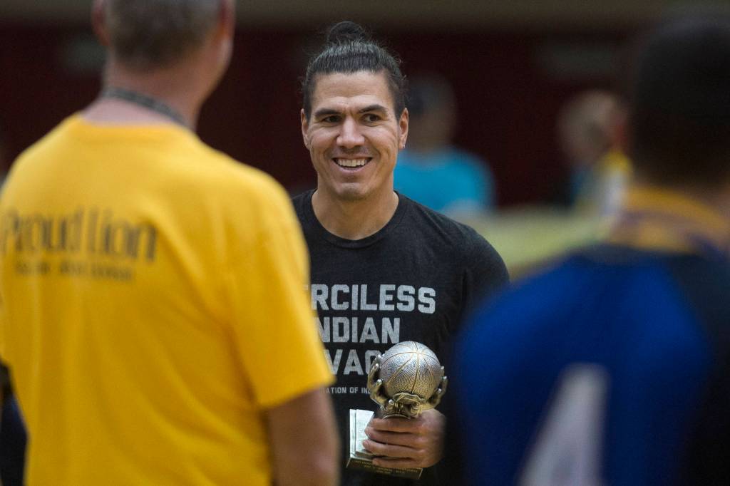 Hydaburgs TJ Young receives his MVP award after Hydaburg beat Klukwan in the C final at the Gold Medal Basketball Tournament on Saturday, March 23, 2019. Hydaburg won 93-81. (Michael Penn | Juneau Empire)