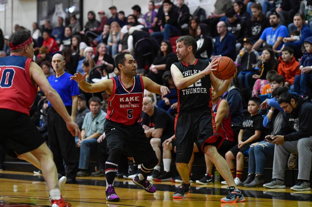 Kakes Rudy Bean defends against Klukwans Dave Buss in the Masters final at the Gold Medal Basketball Tournament on Saturday, March 23, 2019. Kake won 75-64. (Michael Penn | Juneau Empire)