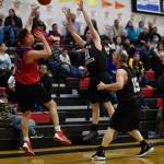 Kakes Lloyd Davis, left, passes against pressure by Klukwans Don Nash, center, and Pete Dohrn in the Masters final at the Gold Medal Basketball Tournament on Saturday, March 23, 2019. Kake won 75-64. (Michael Penn | Juneau Empire)