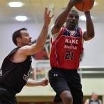 Kakes Kip Howard, right, drives to the basket against Klukwans Scott Forbes in the Masters final at the Gold Medal Basketball Tournament on Saturday, March 23, 2019. Kake won 75-64. (Michael Penn | Juneau Empire)