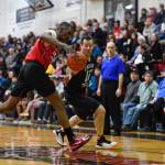 Kakes Kip Howard, left, chases a loose ball agianst Klukwans Scott Forbes in the Masters final at the Gold Medal Basketball Tournament on Saturday, March 23, 2019. Kake won 75-64. (Michael Penn | Juneau Empire)