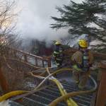Firefighters work the scene of a house fire on North Douglas Highway on Thursday, March 28, 2019. (Michael Penn | Juneau Empire)