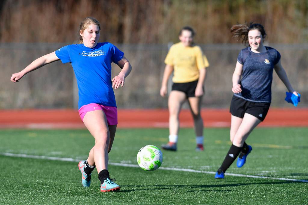 Sally Thompson, left, keeps the ball away from Alina Renz, right, during Thunder Mountain High School girls soccer practice on Friday, March 29, 2019. (Michael Penn | Juneau Empire)