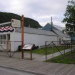 Jeff Smiths Parlor Museum, with attachments, in its current location on the south side of Second Avenue immediately after being moved and rehabilitated by George Rapuzzi. The photographer was Dedman Photo Studio. (Courtesy Photo | National Park Service, Klondike Gold Rush National Historical Park, George & Edna Rapuzzi Collection, KLGO 55876, Gift of the Rasmuson Foundation)