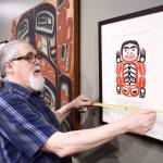 Paul Gardinier, an exhibit specialist, works to install a Nathan Jackson retrospective in the gallery at the Walter Soboleff Center on Monday, March 25, 2019. (Michael Penn | Juneau Empire)
