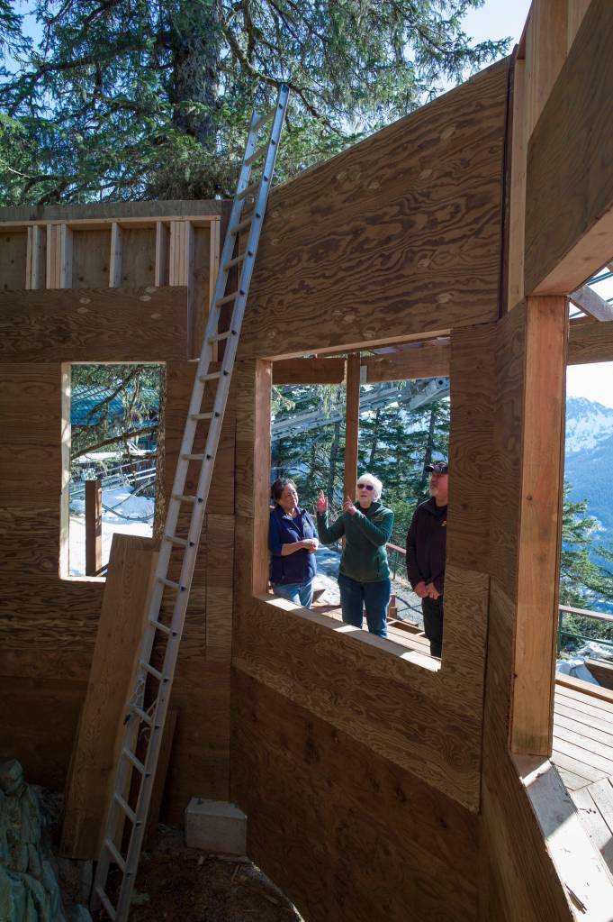 Juneau Raptor Center board members Dale Cotton, left, and Janet Capito, talk Mount Roberts Tramways General Manager Jim Duncan about the construction on a new education display on Mount Roberts on Thursday, March 28, 2019. The display will house Lady Baltimore, an adult bald eagle that is not releasable back to the wild. (Michael Penn | Juneau Empire)