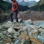 Eric Christensen walks over fallen rock on Perseverance Trail on Tuesday, March 26, 2019. (Michael Penn | Juneau Empire)