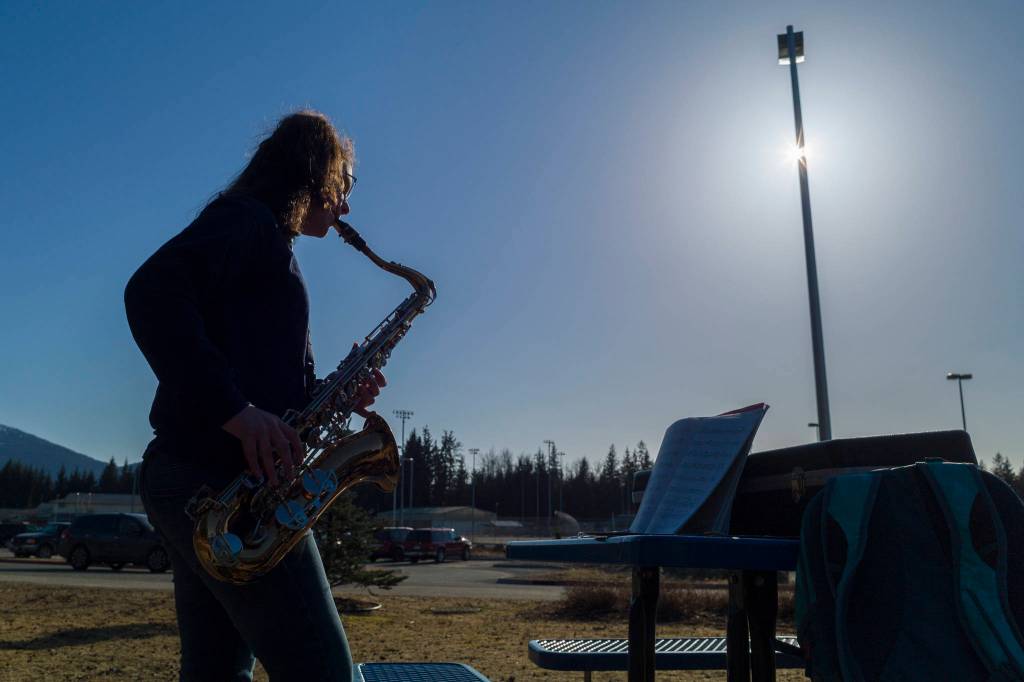 Seveth-grader Allisyn Frazier practices her tenor saxophone outside of the Dimond Park Aquatic Center on Friday, March 29, 2019. (Michael Penn | Juneau Empire)