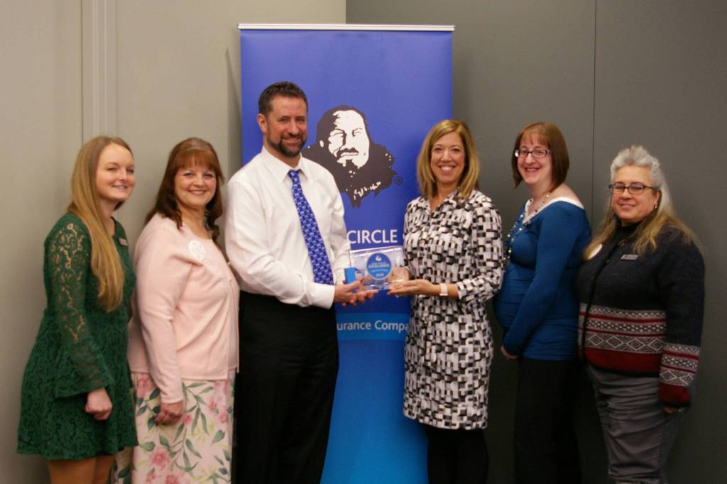Employees of Shattuck & Grummett Insurance with their award. (Courtesy Photo)