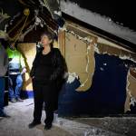 Ernestine Hayes, with her son, Joshua Stephenson, left, and contractor Derik Wythe gives a tour of her fire-damaged house at the corner of 5th and Franklin Street on Wednesday, April 3, 2019. (Michael Penn | Juneau Empire)