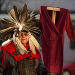 Justin McDonald attends with Native women holding up red dresses to symbolize missing and murdered indigenous women during the Womens March on Juneau in front of the Alaska State Capitol on Saturday, Jan. 19, 2019. (Michael Penn | Juneau Empire)