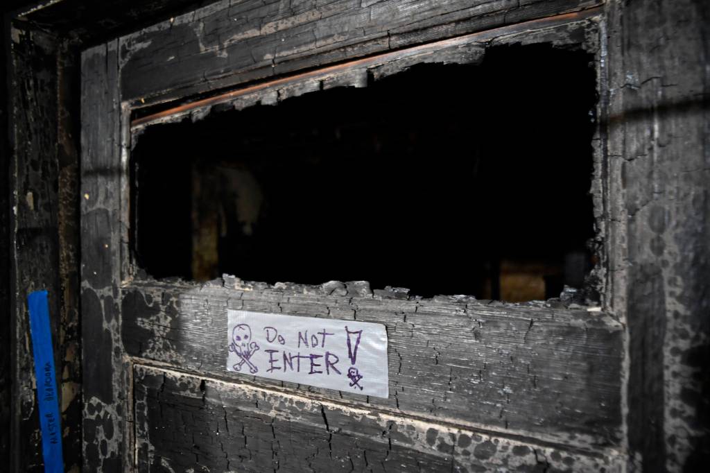Ernestine Hayes gives a tour of her fire-damaged house at the corner of 5th and Franklin Street on Wednesday, April 3, 2019. (Michael Penn | Juneau Empire)