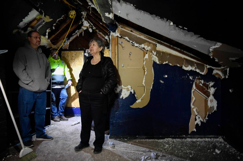 Ernestine Hayesm, with her son, Joshua Stephenson, left, and contractor Derik Wythe gives a tour of her fire-damaged house at the corner of Fifth and Franklin Street on Wednesday, April 3, 2019. (Michael Penn | Juneau Empire)
