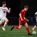 Juneau-Douglas Koby Goldstein, right races against Clarksons Hayden Rogers at Adair-Kennedy Memorial Field on Wednesday, April 3, 2019. Clarkson won 1-0. (Michael Penn | Juneau Empire)