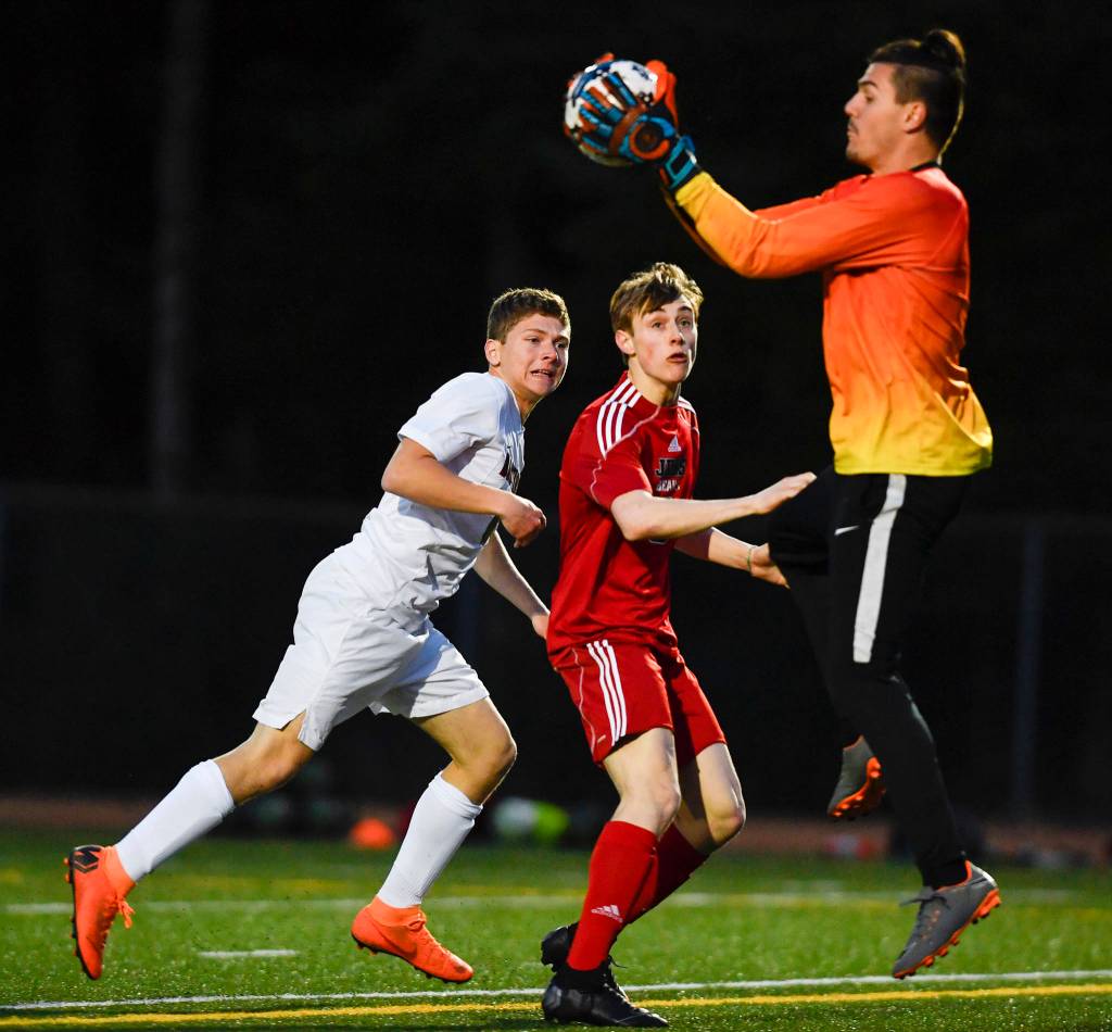 Clarksons goalie Alessandro Italia gathers the ball in front of Juneau-Douglas Koby Goldstein at Adair-Kennedy Memorial Field on Wednesday, April 3, 2019. Clarkson won 1-0. (Michael Penn | Juneau Empire)