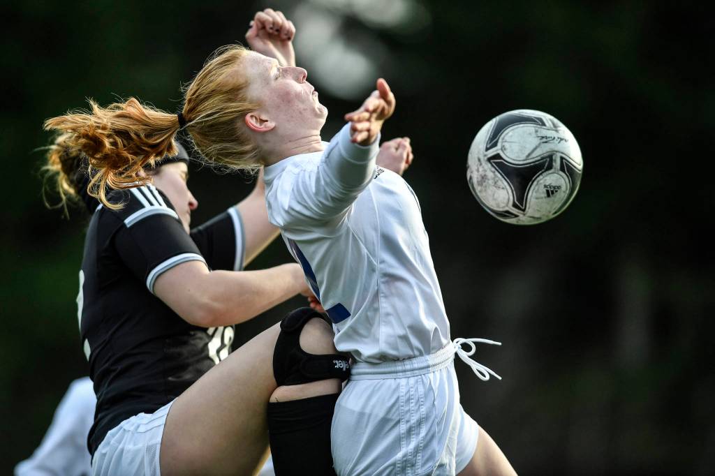 Thunder Mountains Emily Heaton, right, controls the ball against Juneau-Douglas Nikki Box at Adair-Kennedy Memorial Field on Wednesday, April 3, 2019. JDHS won 8-0. (Michael Penn | Juneau Empire)