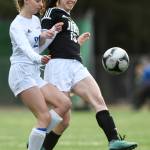 Juneau-Douglas Nicole Mannix, right, kicks the ball away from Thunder Mountains Isabella Hanna at Adair-Kennedy Memorial Field on Wednesday, April 3, 2019. JDHS won 8-0. (Michael Penn | Juneau Empire)