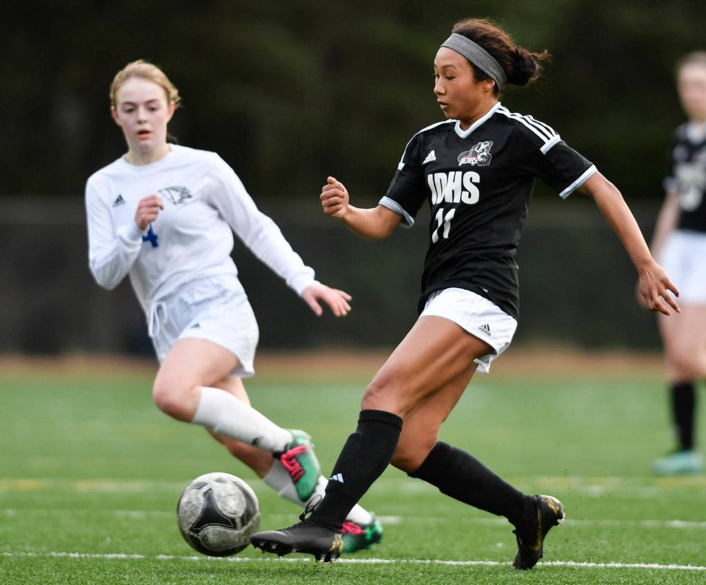 Juneau-Douglas Malia Miller, right, moves the ball against Thunder Mountains Ellie Knapp at Adair-Kennedy Memorial Field on Wednesday, April 3, 2019. JDHS won 8-0. (Michael Penn | Juneau Empire)