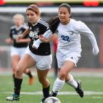 Juneau-Douglas Erica Hurtte, left, competes against Thunder Mountains Molly Brocious for the ball at Adair-Kennedy Memorial Field on Wednesday, April 3, 2019. JDHS won 8-0. (Michael Penn | Juneau Empire)