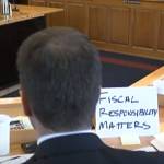 Rep. Dan Carpenter, R-Nikiski, sits at a House Finance Committee meeting on Thursday with a sign that says, fiscal responsibility matters. (Courtesy photo | Gavel Alaska screenshot)