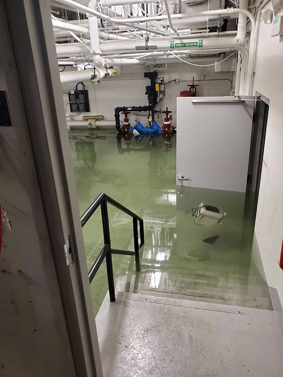This photo shows flooding in the basement of the Marie Drake building on Friday, April 5, 2019. Flooding in a basement boiler room spread diesel fumes throughout the building.(Courtesy Photo | Chris Cairns)